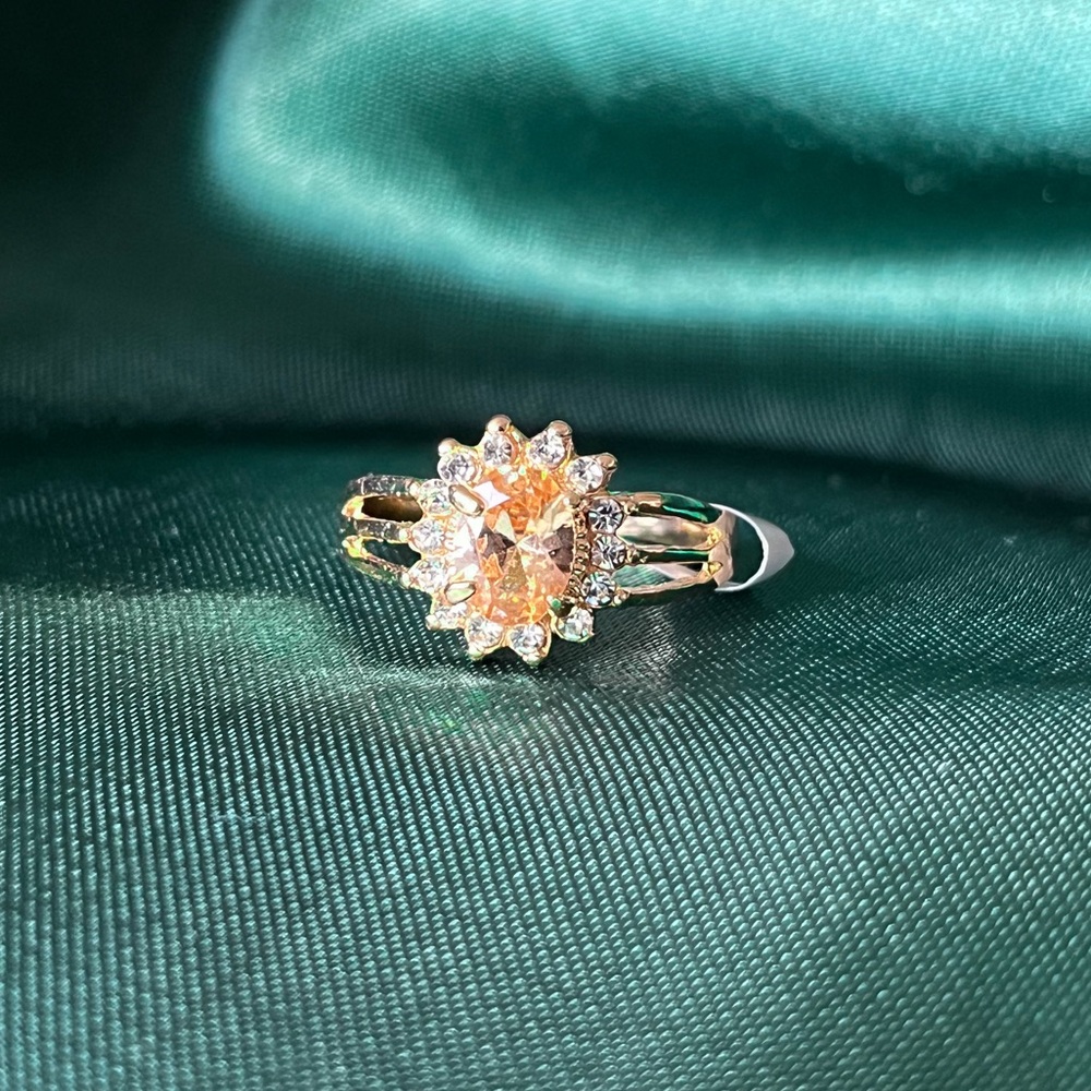 Gold Alloy Ring With An Orange And Clear Gems